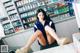 A woman sitting on top of a counter in a pharmacy.