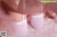 A close up of a woman's legs in white stockings.