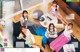 A group of young women sitting on a couch in a living room.